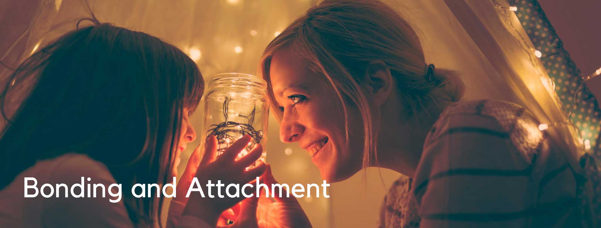 woman and young girl holding a jar with bugs in it.